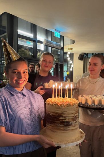 The Bottle & Thyme team celebrating with a birthday cake